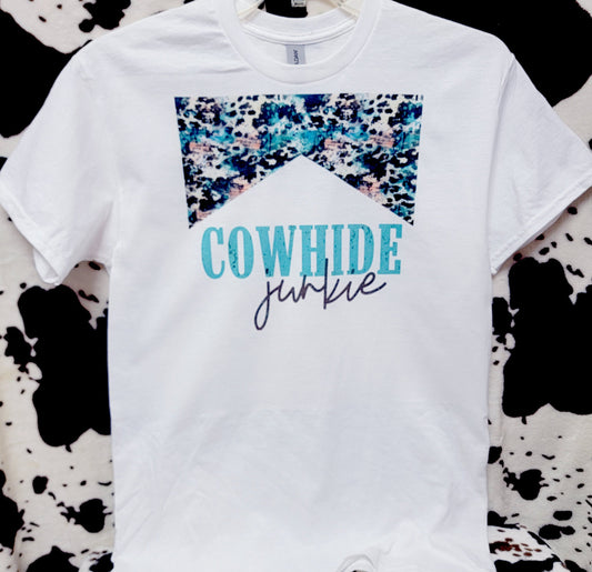 White t-shirt with 'Cowhide Junkie' text on a cow print background