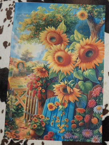 Colorful painting of sunflowers and a garden scene on a textured surface.